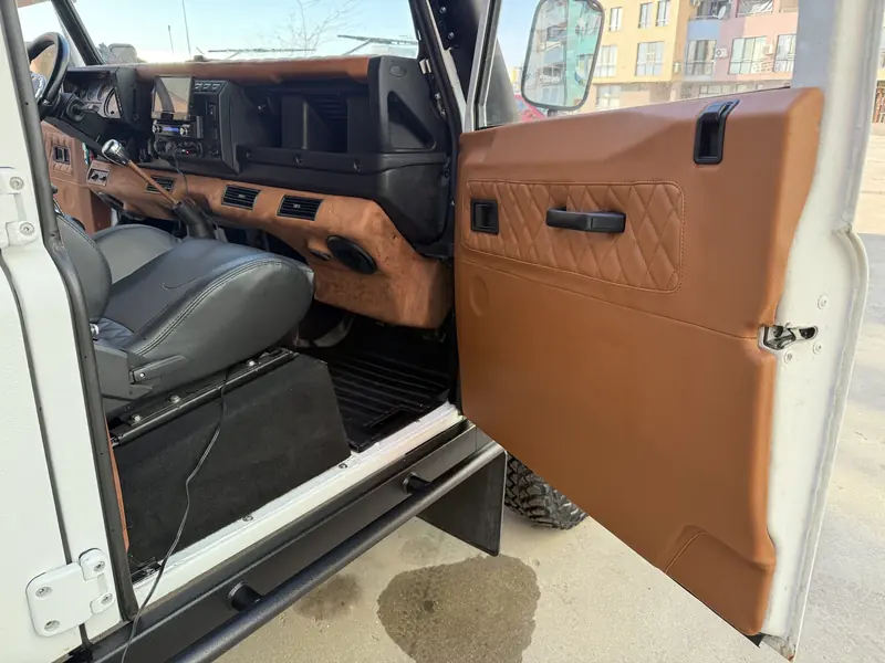 Driver door with leather-trimmed door card