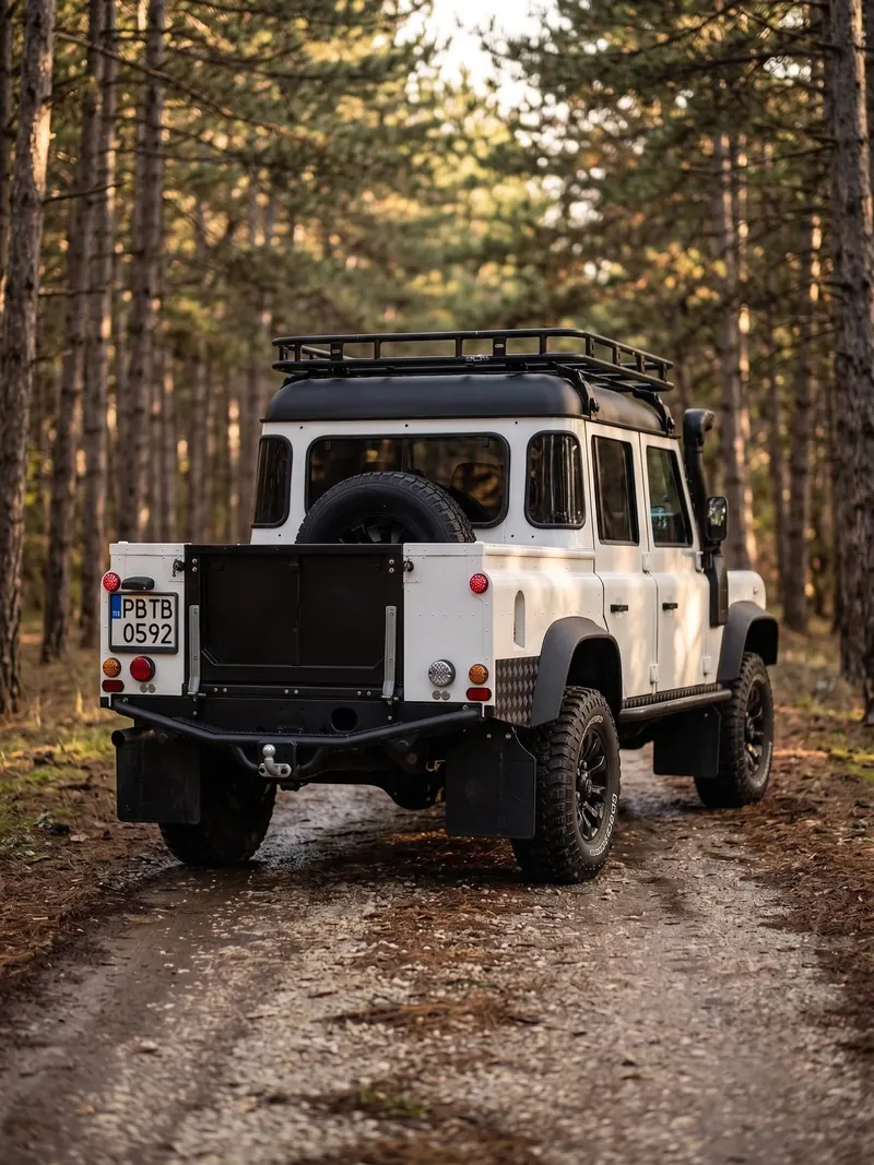 The finished Defender from behind on a forest track