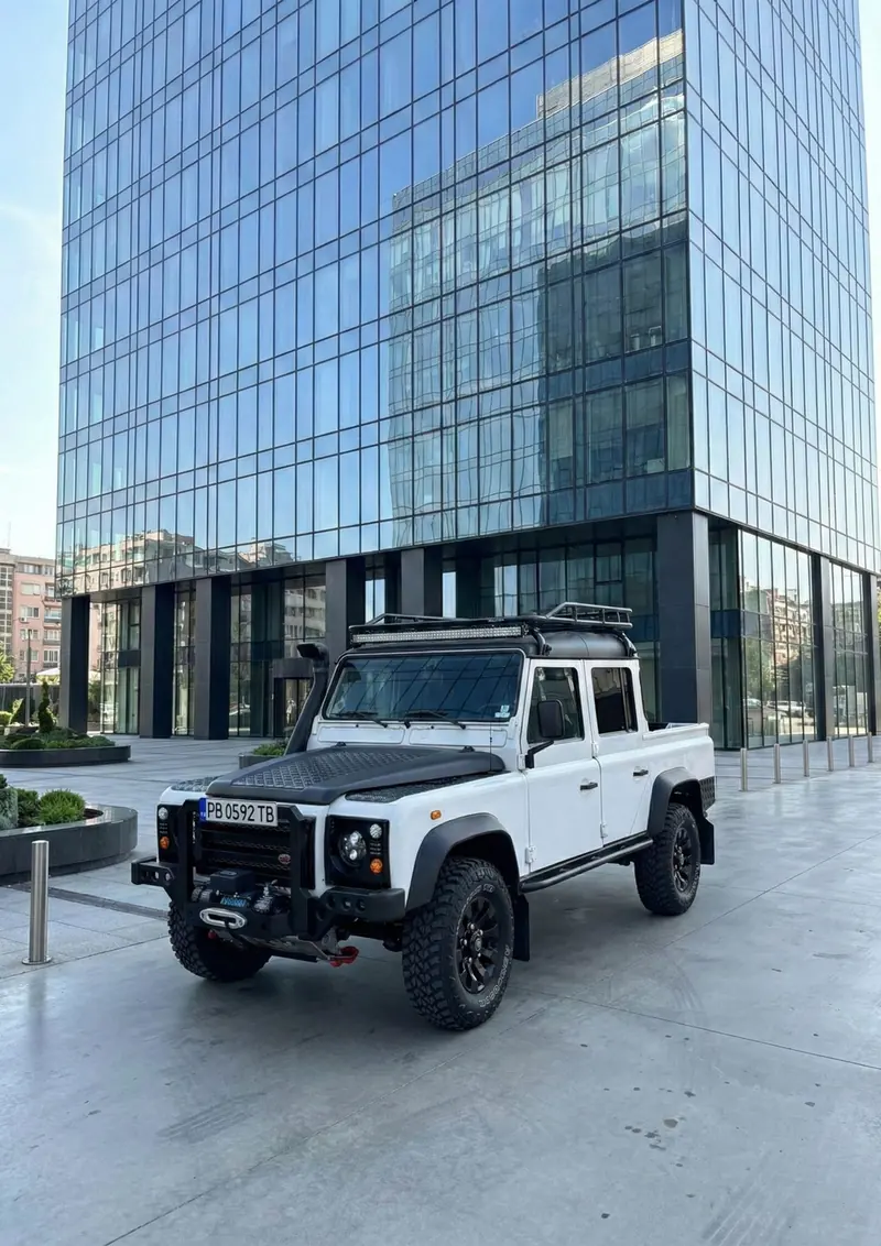 Front three-quarter view by a glass office building