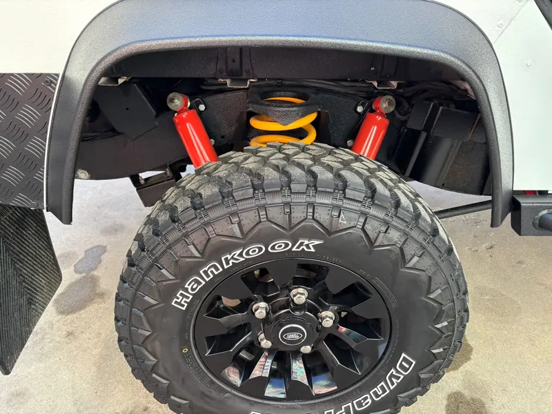 Red shock and yellow spring above a Hankook MT tire